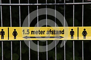 Plastic yellow tape with in dutch language 1,5 meter Afstand to keep people on distance due to the corona covid-19 crisis