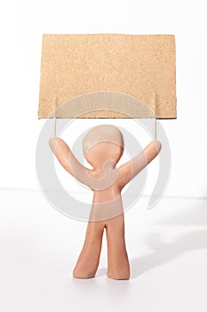 plasticine figure holding a protest banner