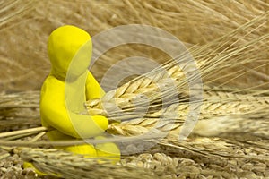 Plasticine figure of a man among the grain, and ears of wheat in