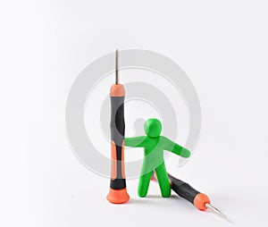 A plasticine figurine of a man holds a screwdriver upright. smartphone repair concept, smartphone repair workshop. White