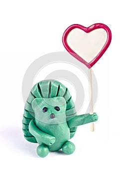 Plasticine hedgehog retaining heart-shaped banner