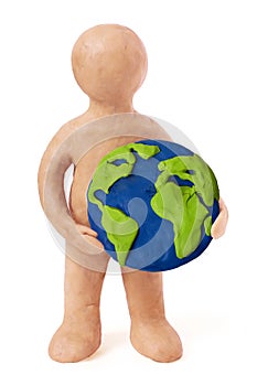 Plasticine man holding earth