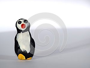 Plasticine penguin. Toys made of plasticine on white background