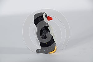 Plasticine penguin. Toys made of plasticine on white background