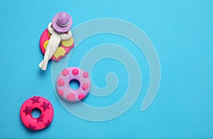 Plasticine people relaxing on inflatable donut lilo in pool. Cartoon summer relaxing and holidays