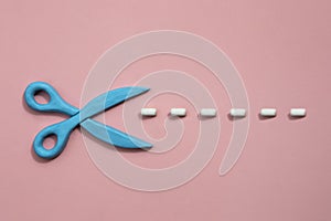 Plasticine scissors with cut lines on pink background. Concept of craft works, design or fashion