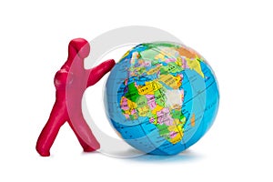 Plasticine small person pushes the globe