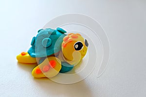 Plasticine turtle on white background, children`s crafts made of plasticine