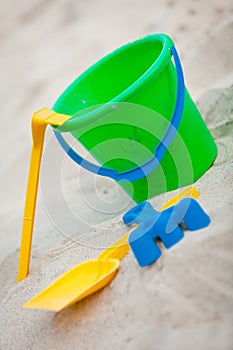 Plastik colorful toys in sand on beach