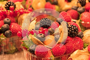 A plastik punnet full of berries on a market/supermarket