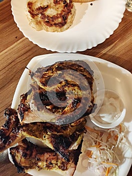 A plate of Al Faham (Arabic Dish) with mayo and Porotta Bread on another plate