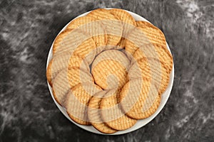 Plate of arrowroot biscuits on a rustic background.