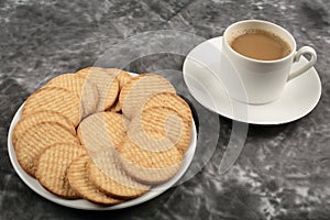 Plate of arrowroot biscuits on a rustic background.