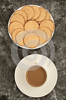 Plate of arrowroot biscuits on a rustic background.