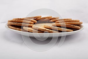 Plate of arrowroot biscuits on a rustic background.