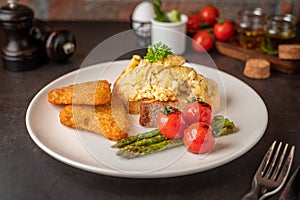Plate of asparagus served with omelet and tomatoes