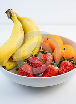 Plate of assorted fruit on a white table