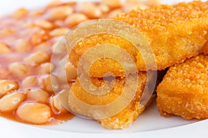 Plate of baked beans with fried fishfingers