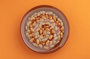 Plate of baked beans in tomato sauce, top view