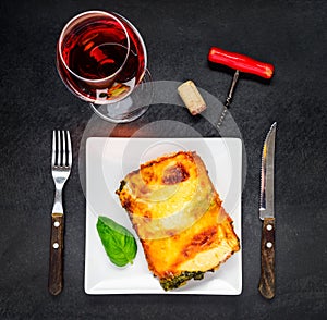 Plate of Baked Lasagna with Glass of Rose Wine