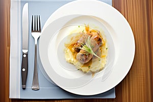 plate of bangers and mash with fork and napkin