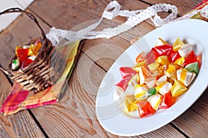 Plate and basket with colorful sweet candies