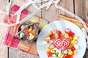 Plate and basket with colorful sweet candies