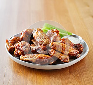 Plate of bbq chicken wings with copy space composition