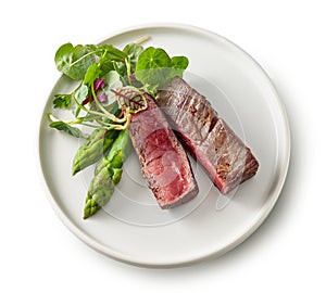 Plate of beef wagyu steak meat with herbs and asparagus