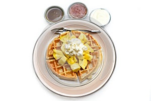 Plate of Belgium waffles with pineapple and ice ream isolated on white background