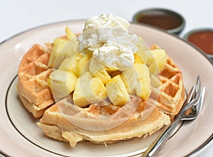 Plate of Belgium waffles with pineapple and ice ream isolated on white background