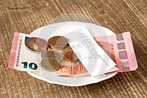 Plate With Bill And Tip On Table