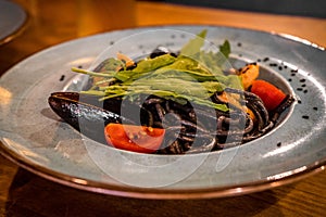 Plate of black spaghetti with sepia ink with a seafood sauce photo