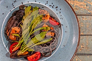 Plate of black spaghetti with sepia ink with a seafood sauce photo