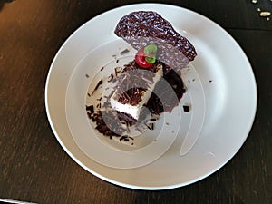A plate of blackforest cheesecake