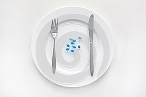 Plate and blue diet pills