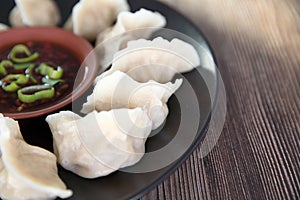 A plate of boiled dumplings and dip
