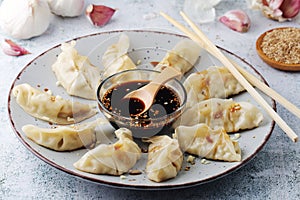 A plate of boiled jiaozi with dipping sauce