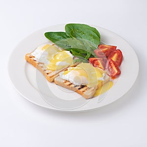 Plate of breakfast with fried eggs, toasts, tomato isolated on white backgound