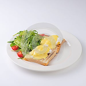 Plate of breakfast with fried eggs, toasts, tomato isolated on white backgound