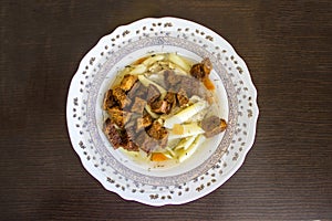 A plate of broth with rusks