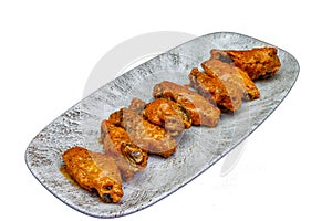 Plate of Buffalo chicken wings on a white background