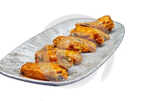 Plate of Buffalo chicken wings on a white background