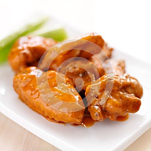 Plate of buffalo wings with celery. photo