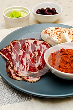 Plate with Bulgarian salami - babek, cheese and chutney photo