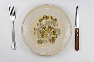 On the plate is bunch of Russian ten-coin lying near tableware view from above