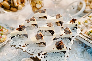 Plate with cakes decorated dessert table for a party. Delicious sweets on buffet. Table with muffins, candy for a party goodies on