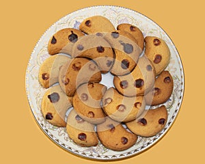 A plate of Chanda Biscuit. three Brown caramel dots on it. traditional bakery item in Chittagong.