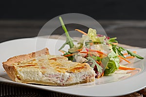 Plate of cheese and potpie with meat and salad