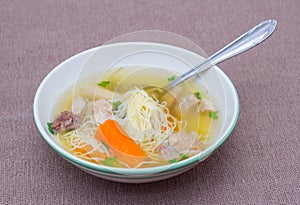 Plate of chicken broth soup